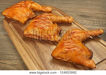 Three Grilled Bbq Chicken Leg Quarter On Wood Board