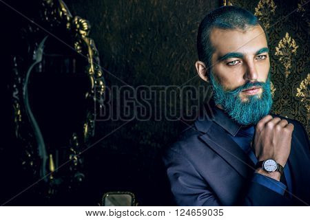 Vintage portrait of a handsome man with blue beard. 