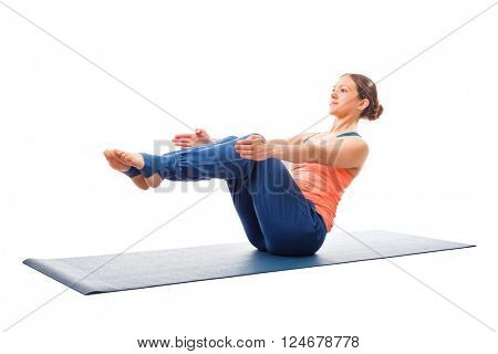 Beautiful sporty fit woman doing Ashtanga Vinyasa yoga asana Paripurna navasana - boat pose beginner variation isolated on white background