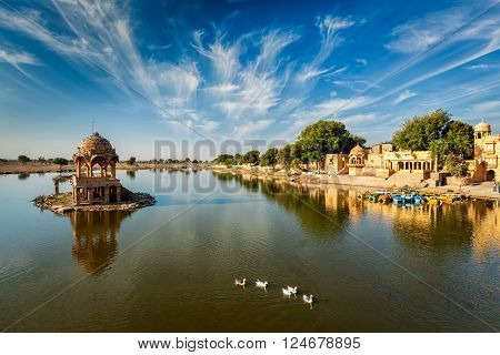 Indian landmark Gadi Sagar - artificial lake with white swans. Jaisalmer, Rajasthan, India