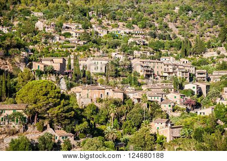 Beautiful view of a small mountain village Deia in Mallorca, Spain. Houses built on hills in Deia mountain village in Majorca island, Spain.