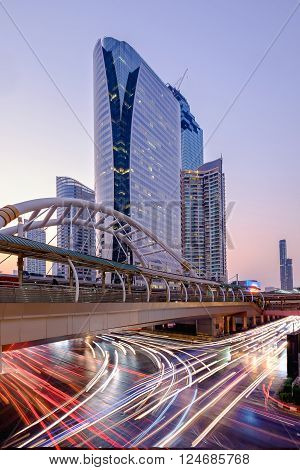 Public sky-walk at sky-train station Chong Nonsi in Bangkok downtown square at twilight time Bangkok Thailand.