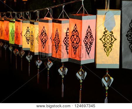 Colorful Lanna paper lantern illuminated at night in Loi Krathong festival or yeepeng lantern festival Thailand