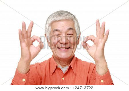 portrait of senior Japanese man showing perfect sign