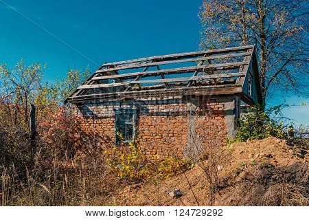 An old abandoned brick house with a broken window, closeup. As background for design of crisis.