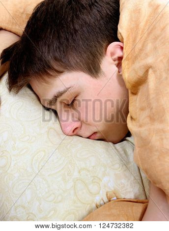 Tired Young Man sleep on the Bed at the Home