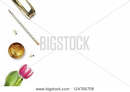 Office desk and woman objects on white table. Flat lay. Tulip gold stapler pencil. Table view. Still life of fashion