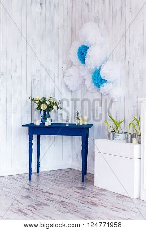 white flowers roses in a blue vase on a blue table with a white wooden background.
** Note: Visible grain at 100%, best at smaller sizes