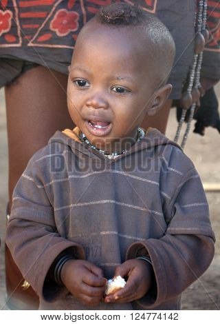 SWAKOPMUND, NAMIBIA OCTOBER 09, 2014: Unidentified child fron Himba tribe living in Mondesa slum of Swakopmund on october 09 2014. In Namibia About 27.6 per cent of households are classified as poor.