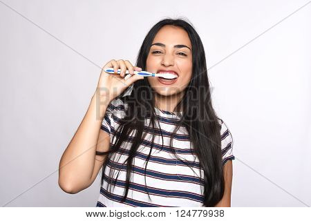 Close-up woman brushing her teeth. Isolated white background.