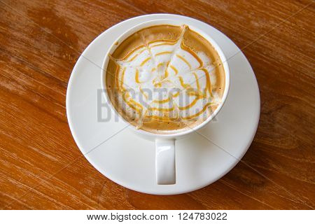 Cup of cappuccino coffee on wooden table