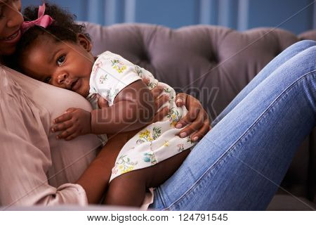 Woman relaxing with her toddler daughter, mid-section crop