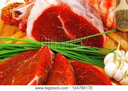 uncooked meat : raw fresh beef pork rib and fillet ready to cooking with garlic and green stuff over wood isolated on white background