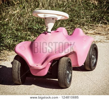 Cute pink toy car in outdoor. Playground theme.