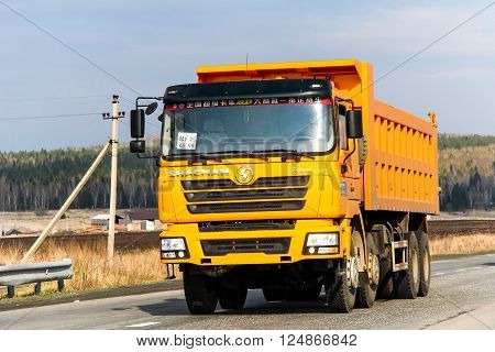 SVERDLOVSK REGION RUSSIA - MAY 8 2012: Yellow dump truck Shacman F3000 at the interurban road.