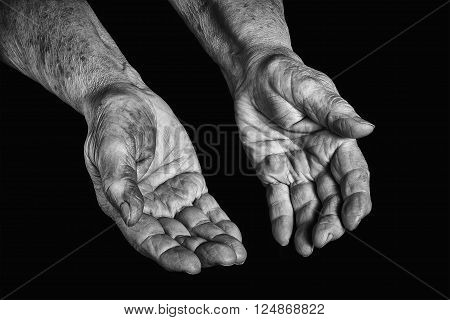 Senior woman hands open on a black background