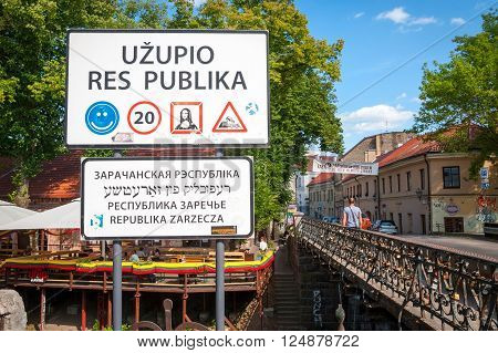 VILNIUS LITHUANIA - JULY 7: Lithuanian road sign before entering Uzupis autonomous artistic community in Vilnius. Uzupis in one of most recognizable city districts. July 2015.