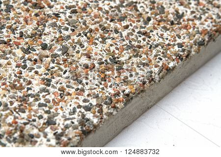 Stone surface with marble chips. View off the edges of the slab.