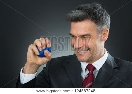 Businessman Pressing Stressball In Hand