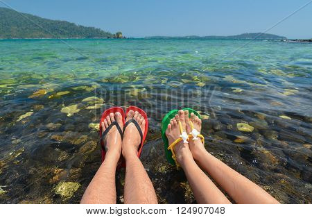 Colorful flipflop sandals on Koh Hin Nham stone beach