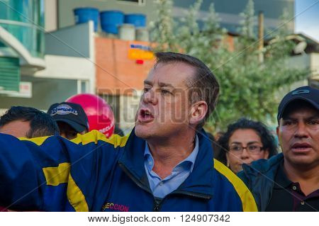 Quito, Ecuador - April 7, 2016: Closeup opposition leader Andres Paez surrounded by people, police and journalists during anti government protests in Shyris Avenue.