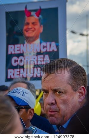 Quito, Ecuador - April 7, 2016: Closeup opposition leader Andres Paez surrounded by people, police and journalists during anti government protests in Shyris Avenue.