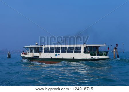 Venice, Italy - March 17, 2016: Vaporetto (water bus) at Venice canal. Vaporettos are a traditional, flat-bottomed Venetian motor boat, well suited to the conditions of the Venetian lagoon