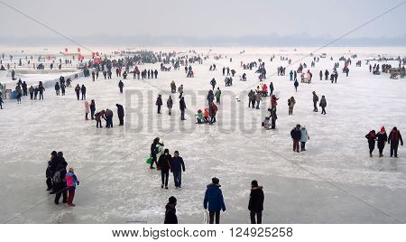 HARBIN CHINA - JANUARY 15 2016: Local life during the 32nd Harbin Ice Festival. The main attraction is the Harbin Ice and Snow World which covers more than 750000 square meters