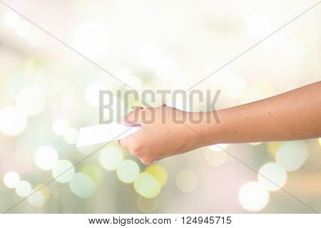 Hand holding empty white paper isolated on white background.
