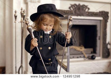 Girl as a chimney sweep against fireplace. Lucky New Year's Eve and New Year.