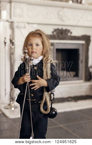 Girl as a chimney sweep against fireplace. Lucky New Year's Eve and New Year.