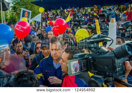 Quito, Ecuador - April 7, 2016: Closeup opposition leader Andres Paez surrounded by people, police and journalists during anti government protests in Shyris Avenue.