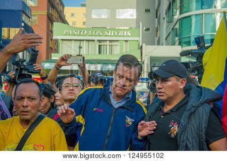 Quito, Ecuador - April 7, 2016: Closeup opposition leader Andres Paez surrounded by people, police and journalists during anti government protests in Shyris Avenue.