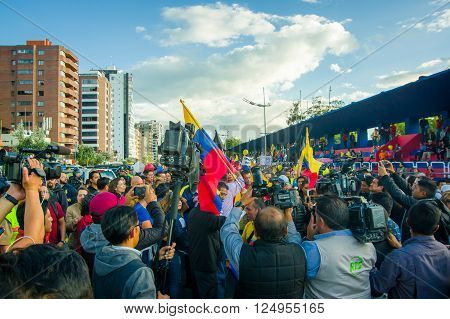 Quito, Ecuador - April 7, 2016: Closeup opposition leader Andres Paez surrounded by people, police and journalists during anti government protests in Shyris Avenue.