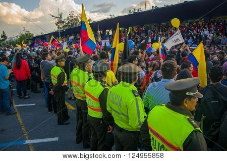 Quito, Ecuador - April 7, 2016: Police awaiting overlooking peaceful anti government protests in Shyris Avenue, beautiful blue sky and buildings background.