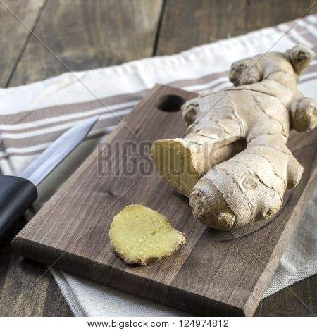 Fresh ginger root on a cutting board close up