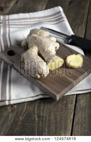 Fresh ginger root on a cutting board close up