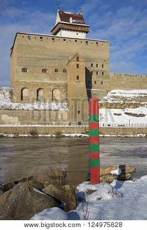 Russian border post on the background of the Hermann castle in Narva. View from Russia to Estonia