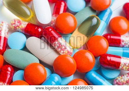 Many pills in pile different colours. Close up. Concept of medicines.