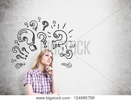 Research concept with female and question mark sketches on concrete wall