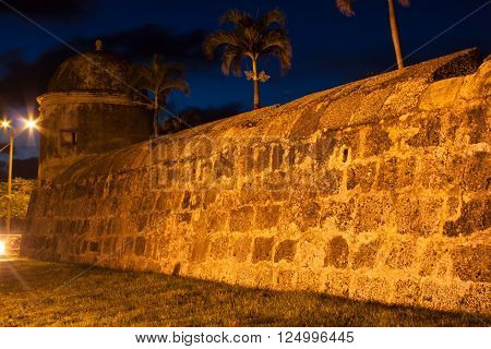 Cartagena's wall at dusk under street tungsten lights