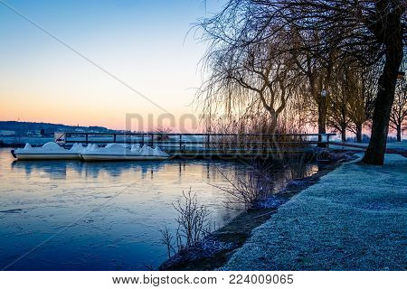 A Small Frozen Pond In The Early Morning After An Icy Night In Limburg, South Netherlands.