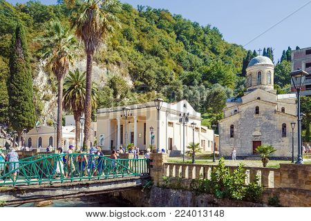 NEW ATHOS, ABKHAZIA, GEORGIA, 19 SEPTEMBER 2017: View of the bridge across the river and the Saint Simon the Canaanite Church