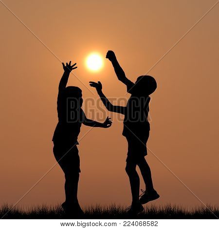 Black children silhouettes playing with the sun