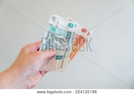 a woman's hand holds a five thousandth note. Russian money. The concept of a bribe. selective focus. light background.