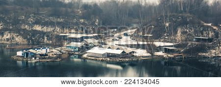 Panorama of the little workers industrial houses on the lake in the quarry, tilt-shift effect