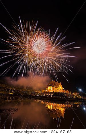 Fireworks celebrate the New Year 2018 at Rajapruek Royal Park, Chiang Mai with beutiful light of Hor Khum Luang temple,Thai Tradition Building.