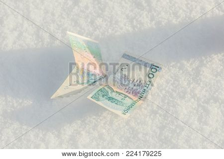 Banknotes of old Belarusian rubles samples withdrawn from circulation dropped down to the snow
