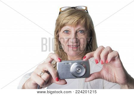 Retired senior woman using her compact camera to take some snapshots, white background