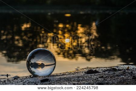 sunset closed to the ball by the lake in the forest